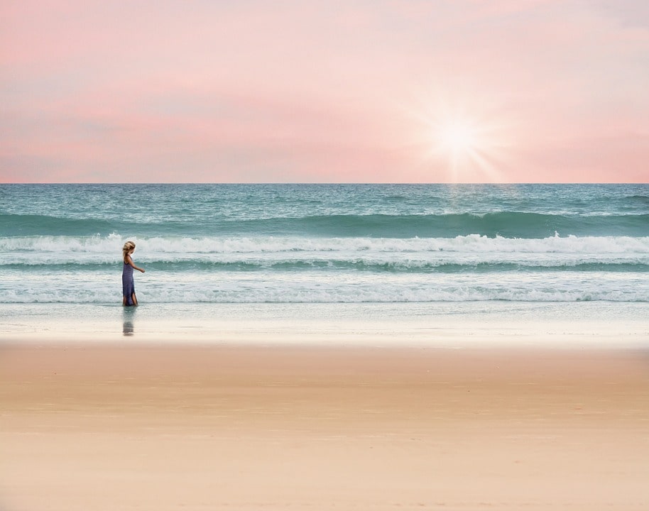 She was walking on a beach when she found a bottle on the sand.