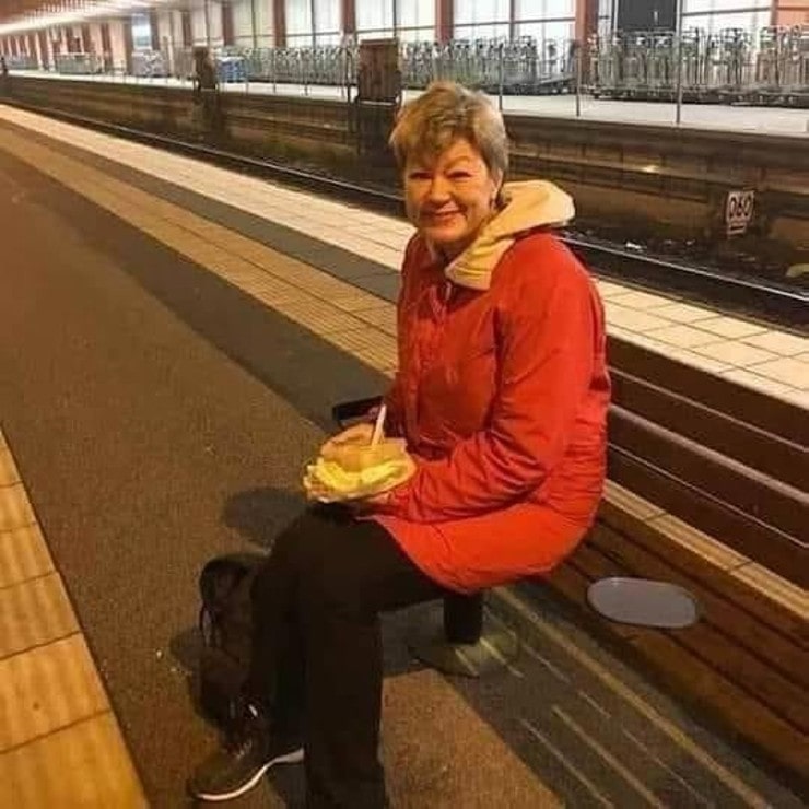 A woman is waiting for a train headed back home.