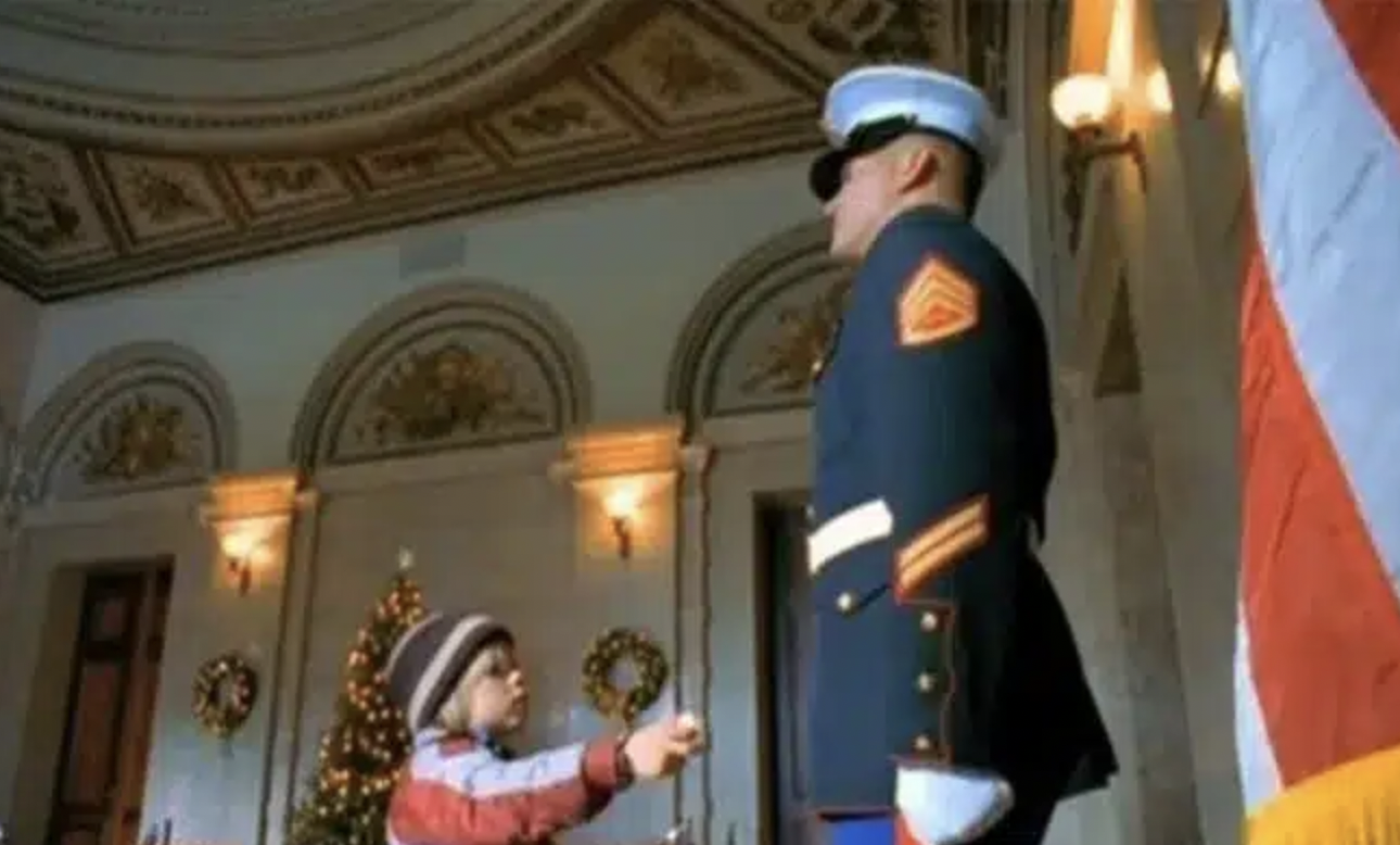 Marine Guard ignores this little boy; however, check out what he does with his hand seconds later…