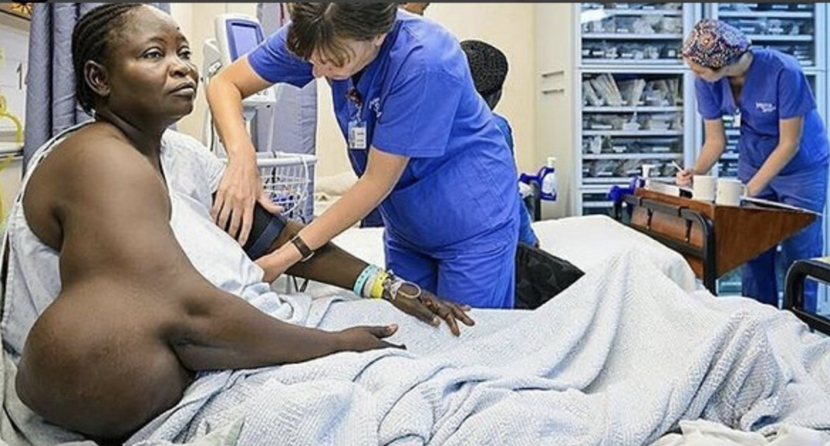 As a large tumor is surgically removed from her arm, a woman is happy…