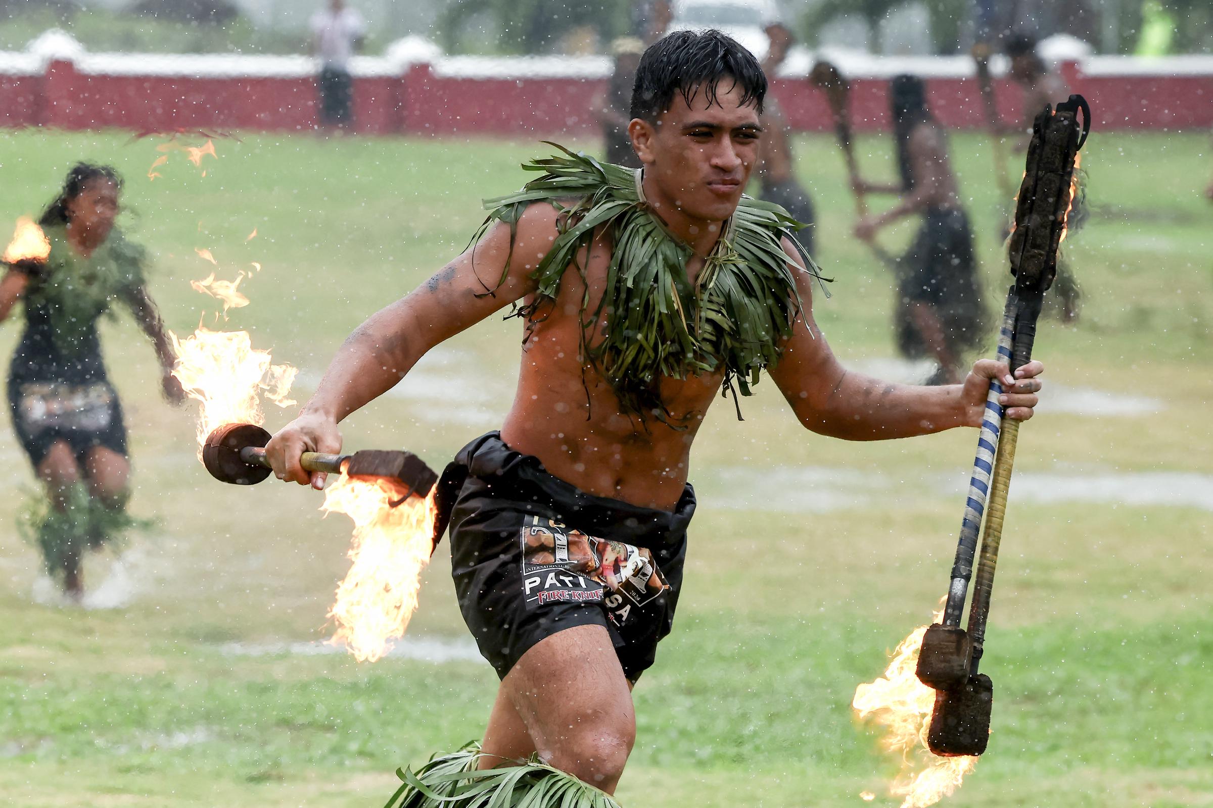 A Samoan villager performing for Queen Camilla and King Charles III. | Source: Getty Images